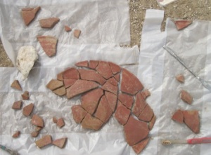 Bowl fragments being reassembled