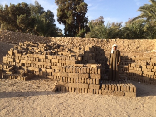 Stacks of new mud bricks. This is a stack of about 3,000 bricks. Can you imagine what a stack of approximately 400 times more bricks would look like?